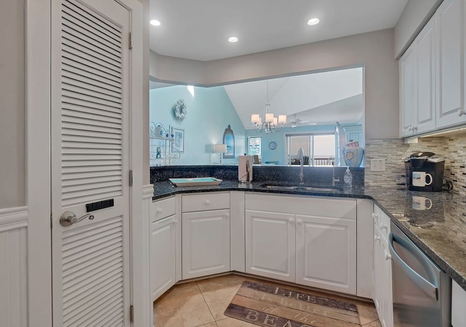 Reverse osmosis faucet at the kitchen sink. Pantry, stainless appliances.