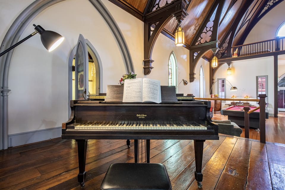 Baby grand piano in main Church