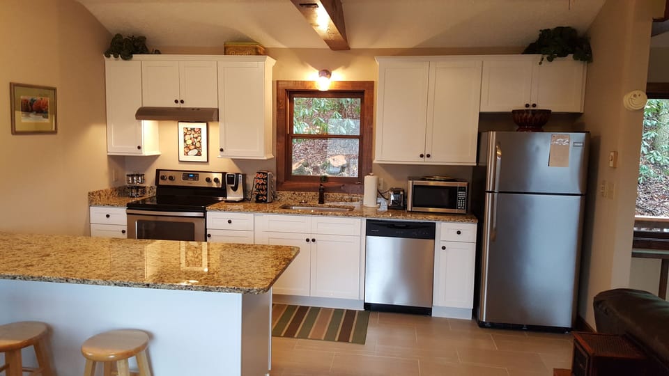 New kitchen with stainless steel appliances and granite countertops.
