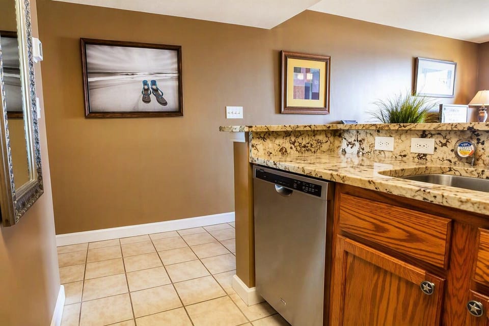 Elegant kitchen featuring rare granite countertops—an upgrade not commonly found in this complex.