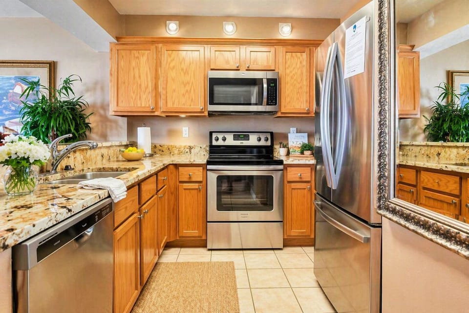 Bright, modern kitchen with granite countertops and stainless steel appliances.