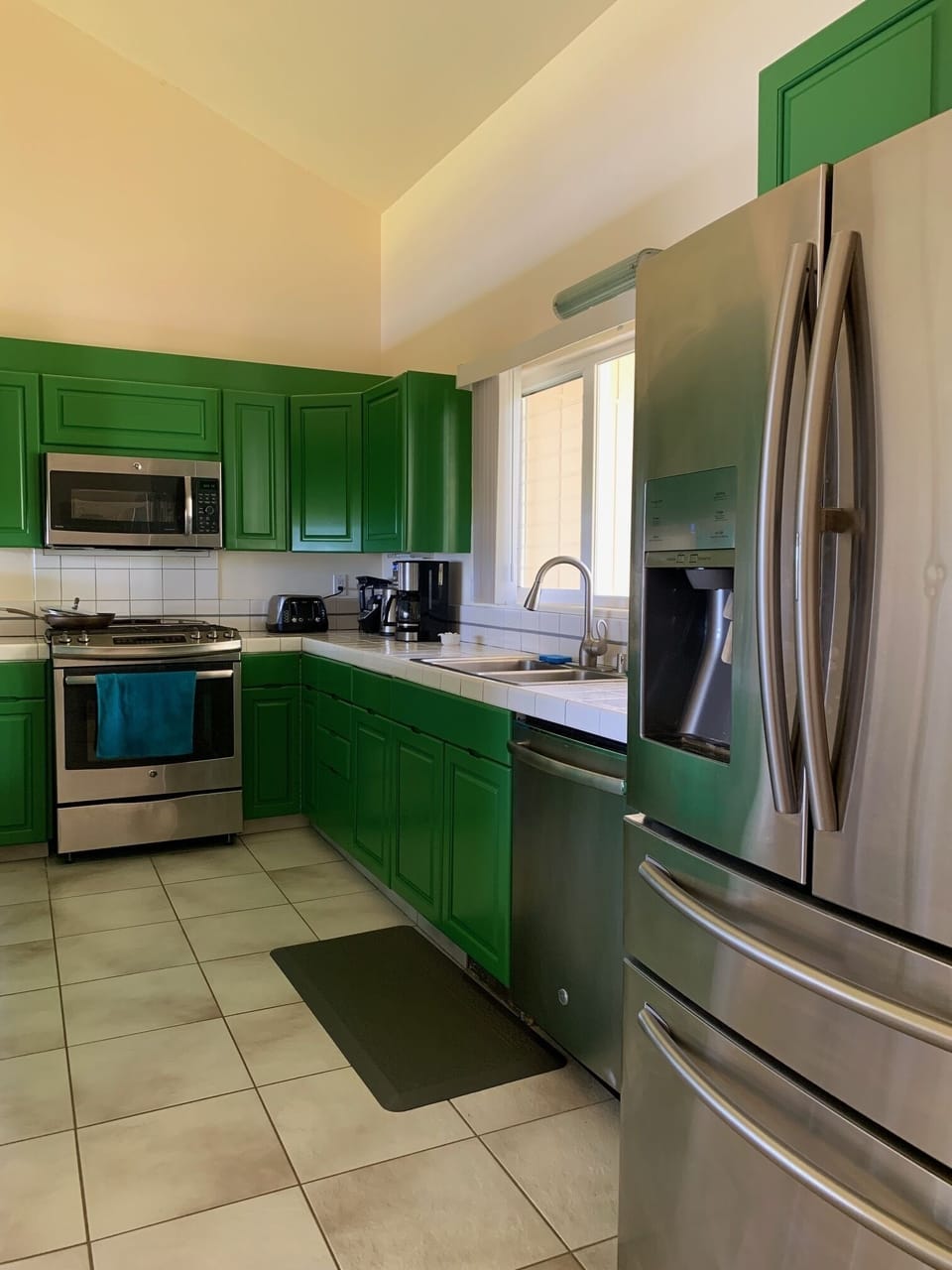 Kitchen cabinets, now painted a cheerful,  garden-green color