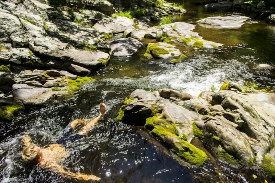 Guest floats down stream in the river, enjoying fresh, cool, clear waters.