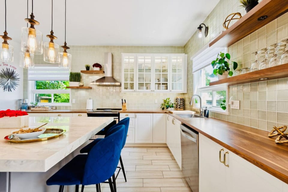 A bright and fully equipped modern kitchen, perfect for cooking and gathering together.