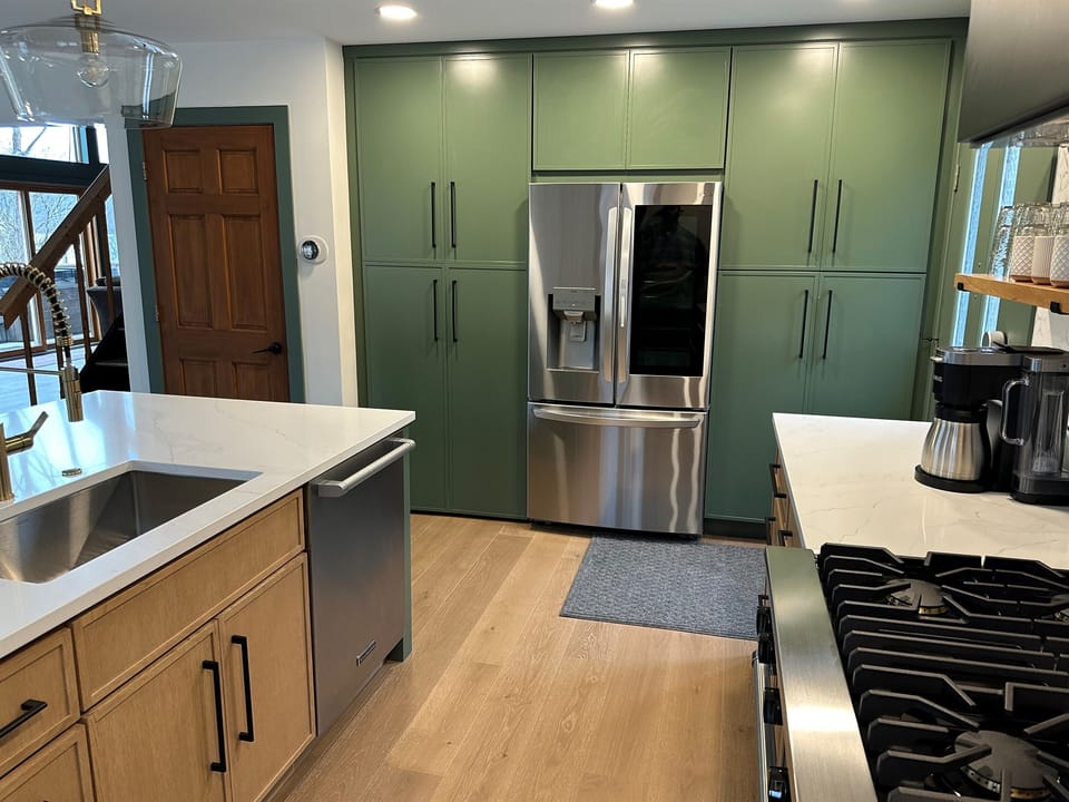 LG Washtower laundry unit is in the cabinet to the left of the fridge.