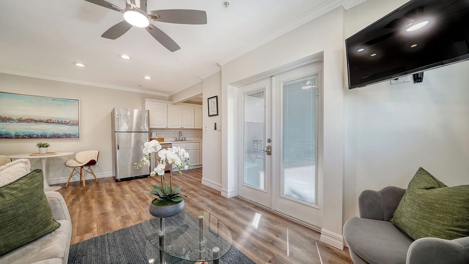 Entrance into the apartment, lots of natural light and a patio with pool view
