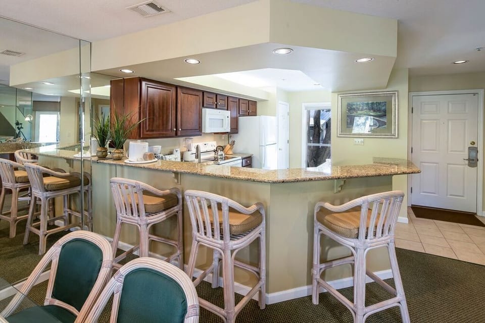 Full size kitchen with granite counter-tops and breakfast bar. 