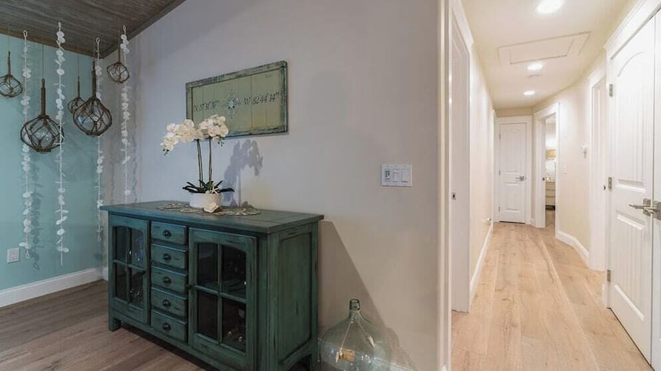 Hallway closet to laundry area washer and dryer in doors.