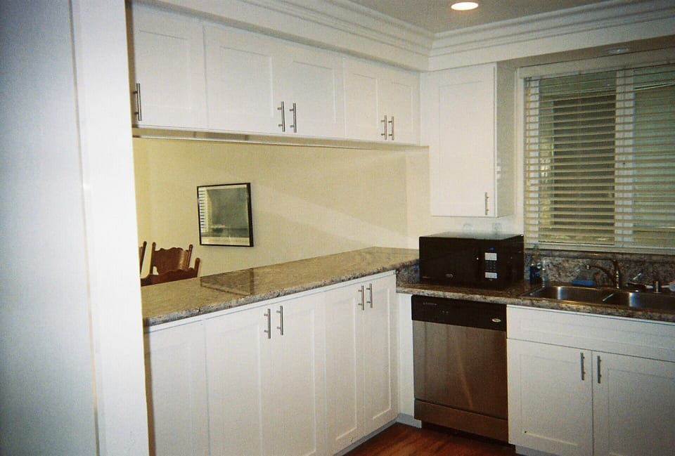 New Granite counters and white shaker cabinets, and brushed nickel hardware 