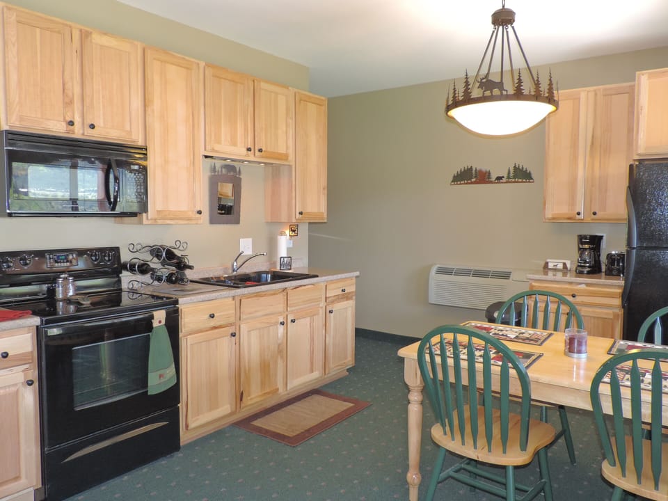 Full kitchen, walks out to patio overlooking Yellowstone River w/ mountain views