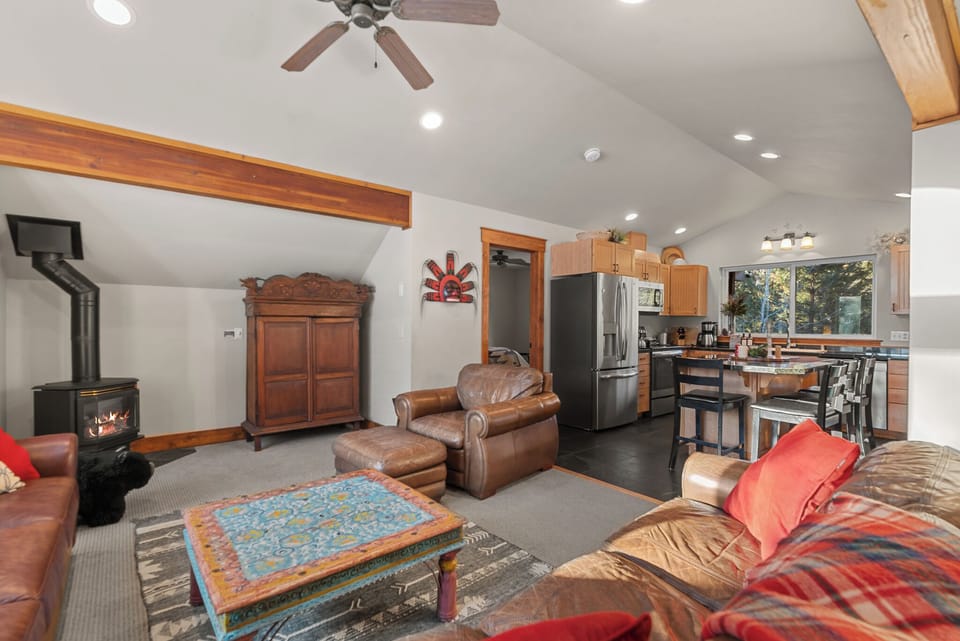 Open concept upstairs living room and kitchen with island 