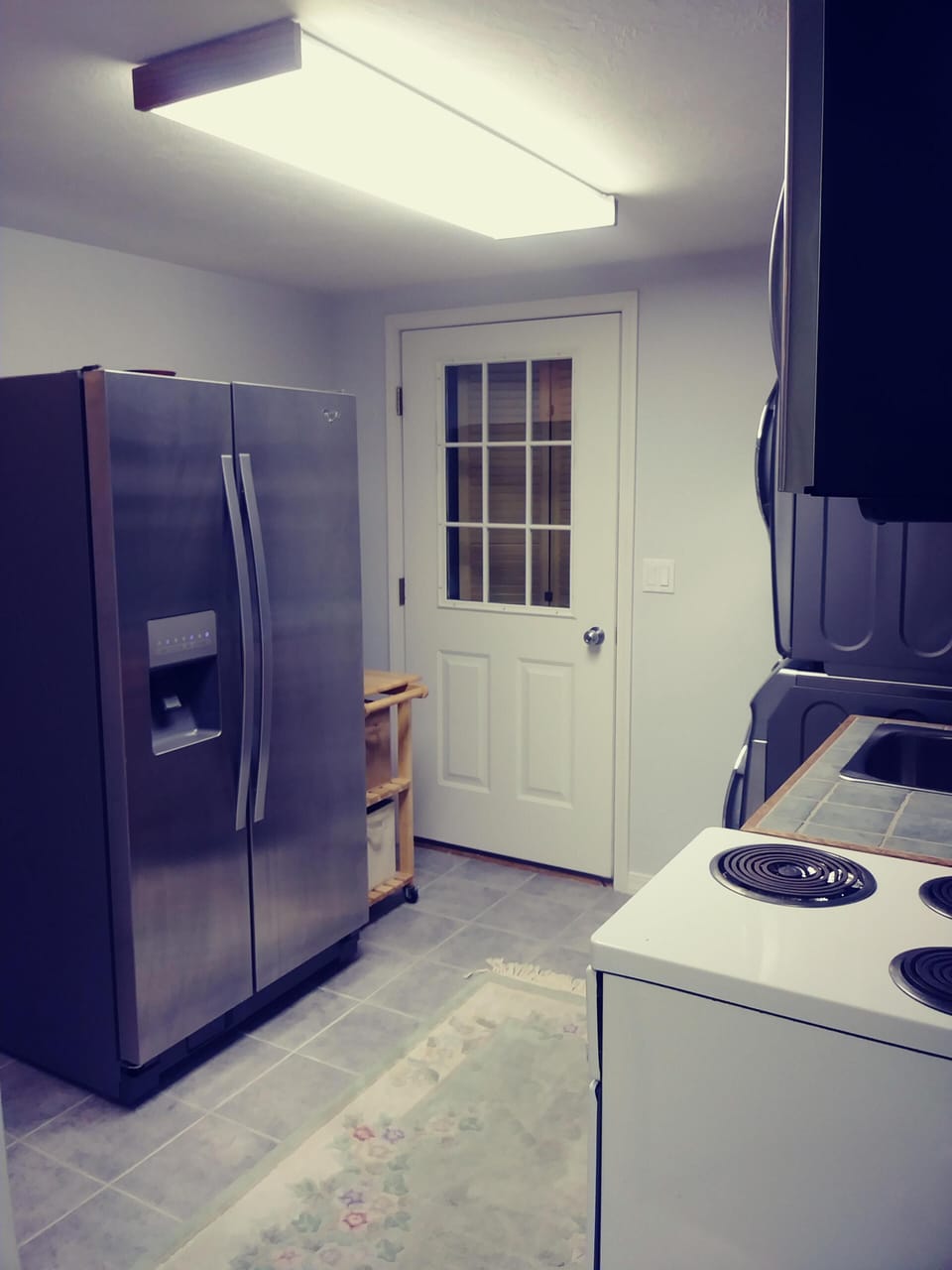 Full sized fridge/freezer in small kitchen.