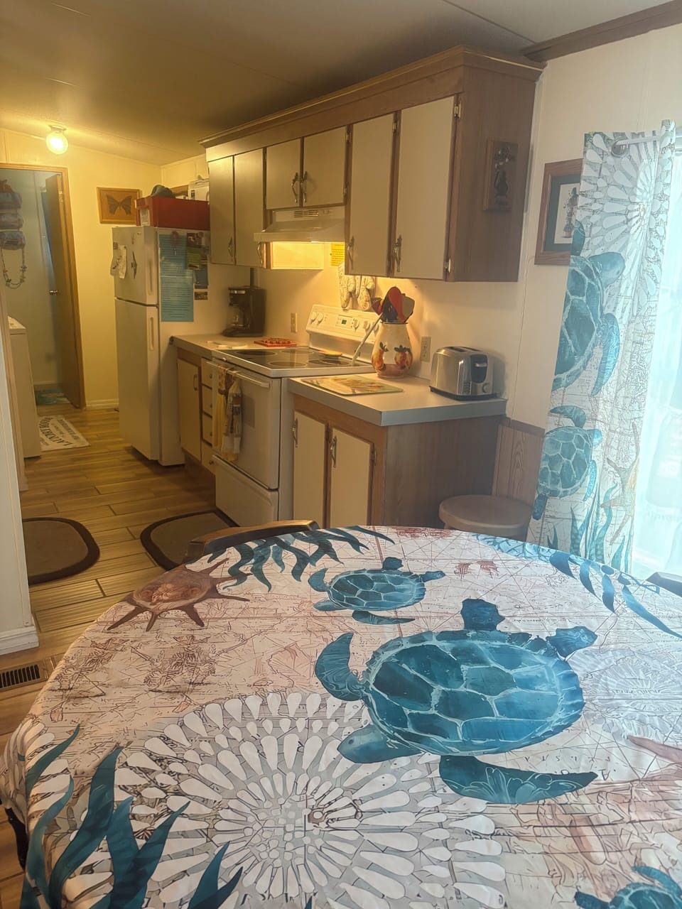 Dining table across from living room and kitchen. Leads to back door/main bath