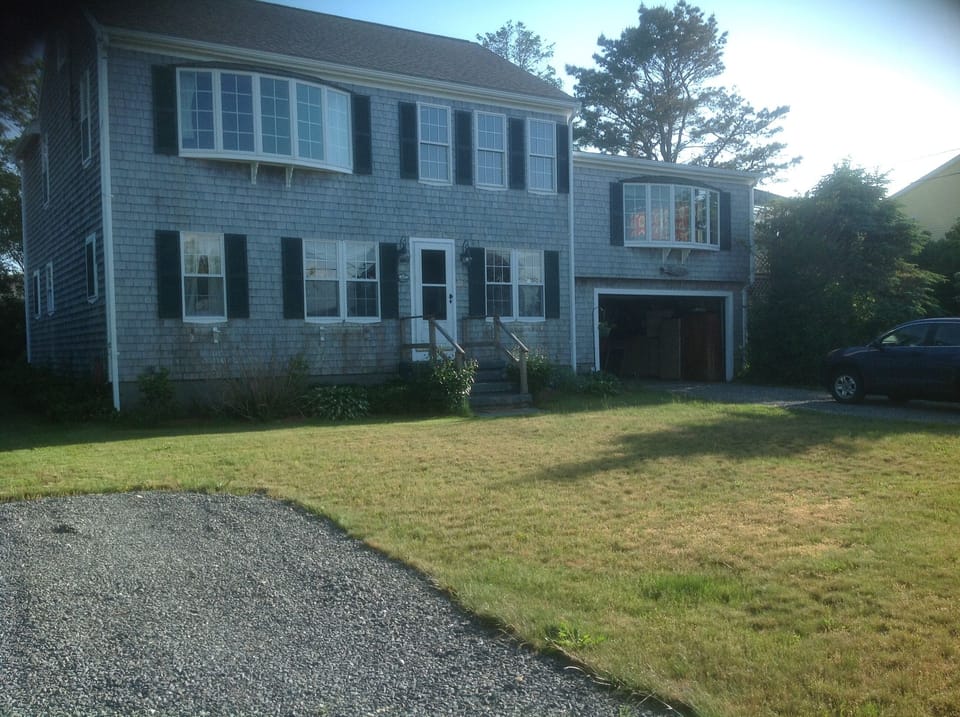 Two story colonial on Town Neck with two driveways and two decks.