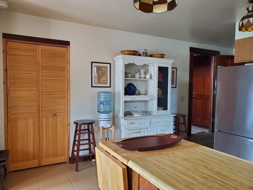 Kitchen has walk-in pantry behind pine bifold door!