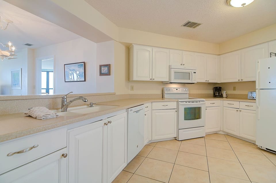Fully equipped kitchen with lots of counter space and a view of the ocean.