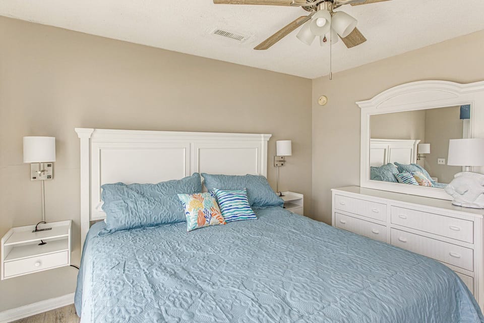 Dresser with lights, charger, and storage on both sides of the bed.