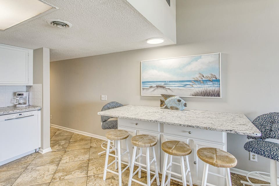 Enjoy eating at the granite countertop  bar with stools.