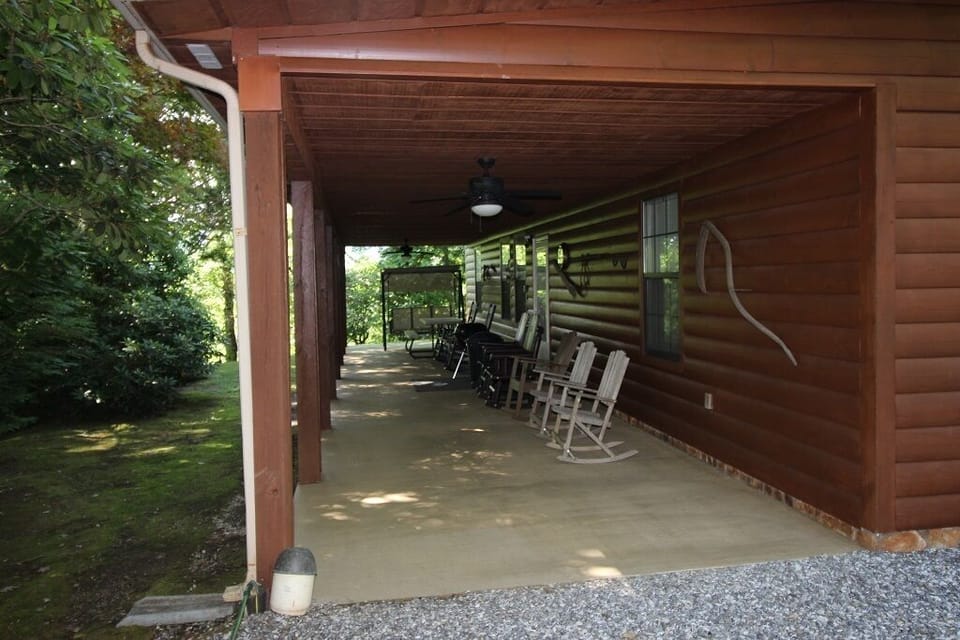 Porch with rocking chairs and swing.