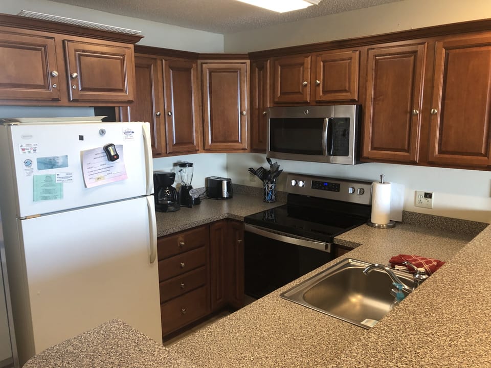 Fully stocked kitchen, including newer electric range and microwave.