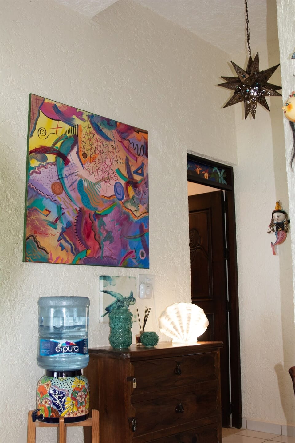 The hall with it's contemporary painting and hand tooled star light fixture