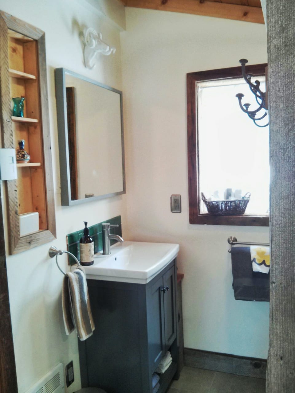 Newly renovated main floor bathroom features  barnwood trim from the property.