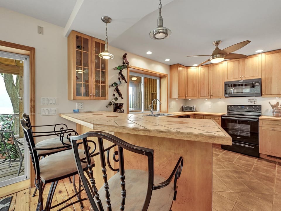 The bar separates the kitchen, keep an eye on what's cooking and happening.