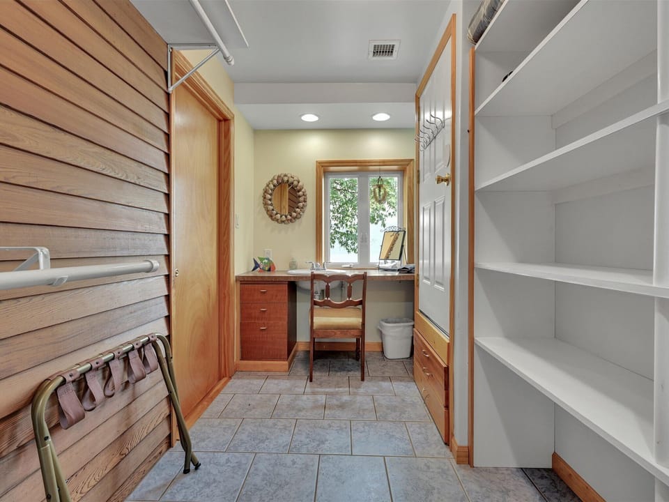 Attached to master bedroom, private dressing room/closet with sink vanity.