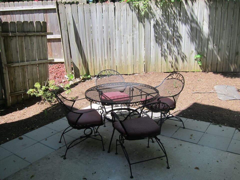 The back patio has table and chairs for entertaining and enjoying.