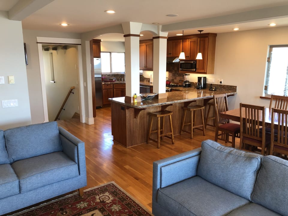 Open kitchen with bar stools at counter.