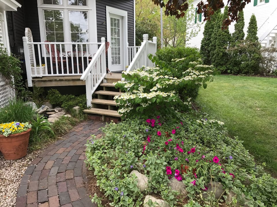 Steps to porch entrance with fountain on left