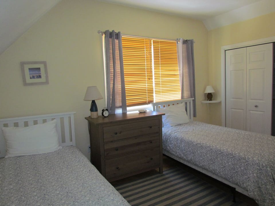 Second floor bed room with two single beds.
