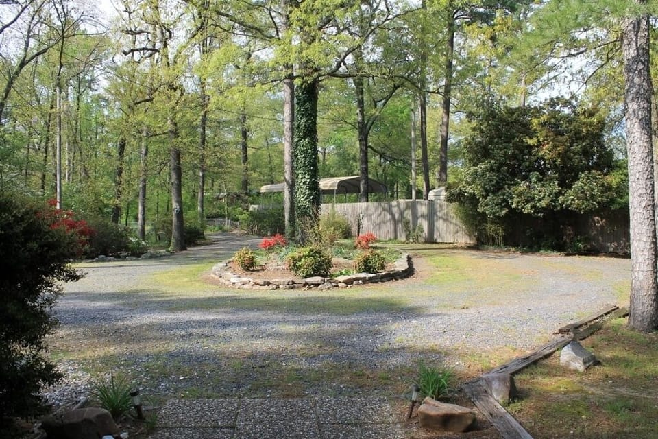 view from front porch, circular drive, privacy fence.