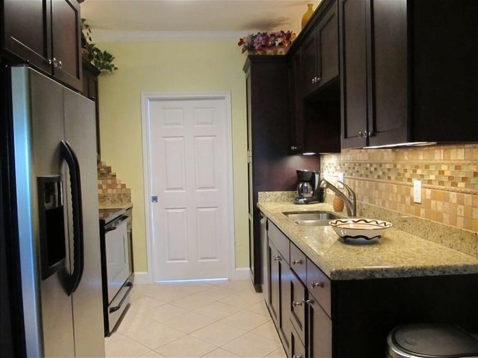 Kitchen with stainless steel appliance, ice maker, dishwasher, granite counters.