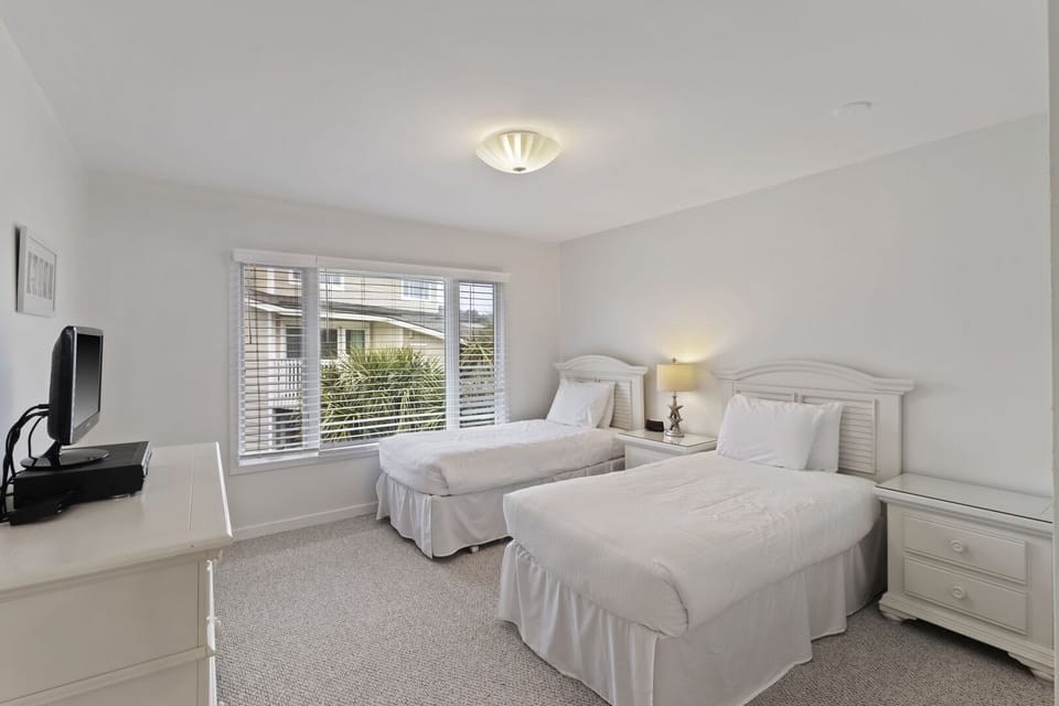 Bedroom with two twins, TV and private bathroom.