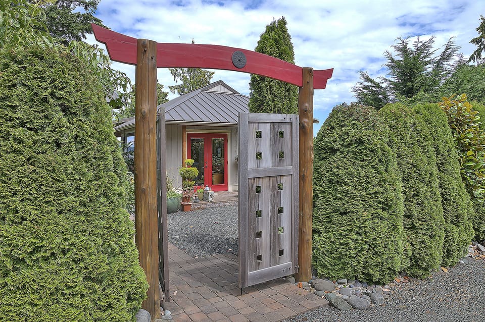 Enter into Seaclusion Guest Cottage. Park along the hedge to right.