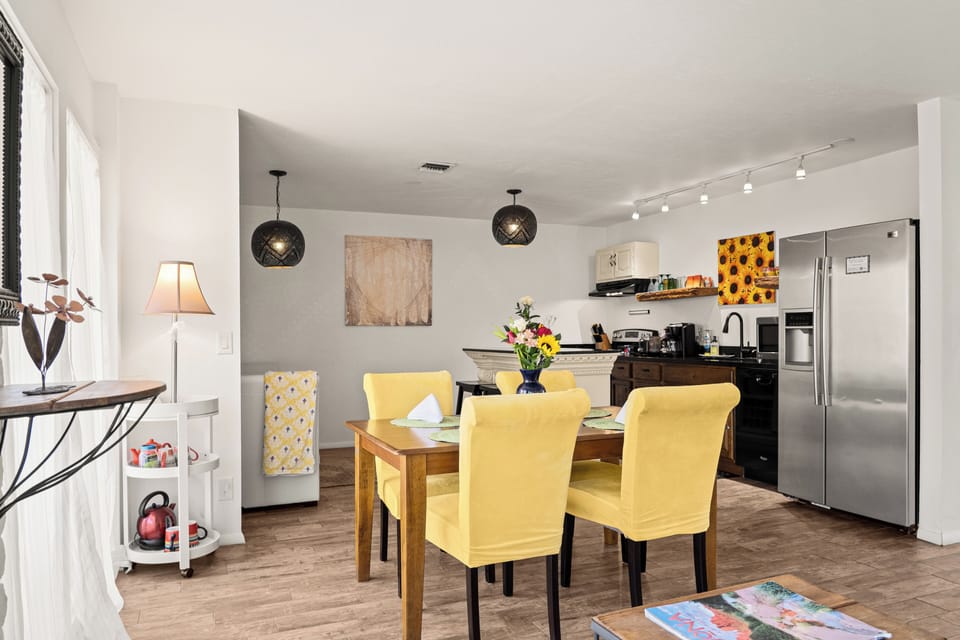 Dine-in kitchen with stainless appliances and bar seating.