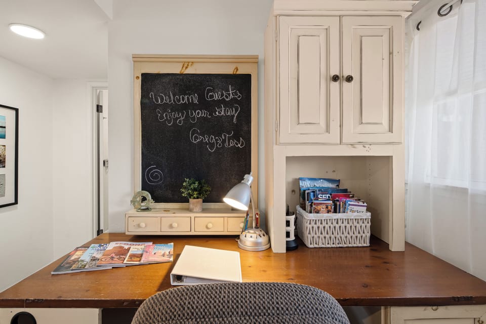 Workspace with welcome chalkboard + curated Sedona guides.