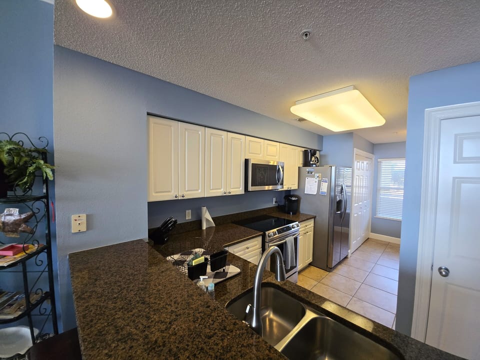Kitchen space with washer and dryer in the back. 
