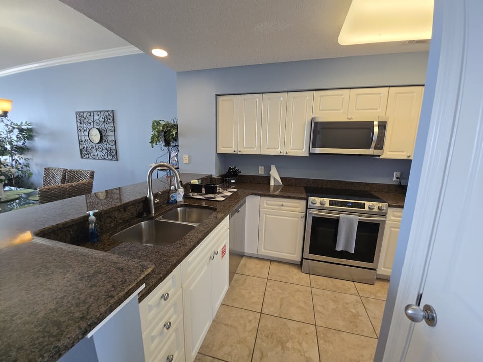 Kitchen includes double sinks, dishwasher, oven, microwave and fridge. 