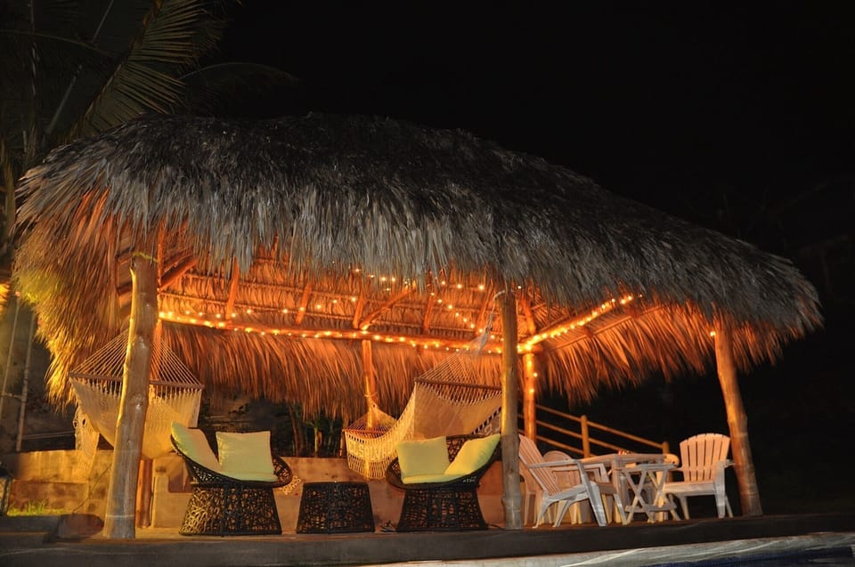 Night view of poolside ranch. 