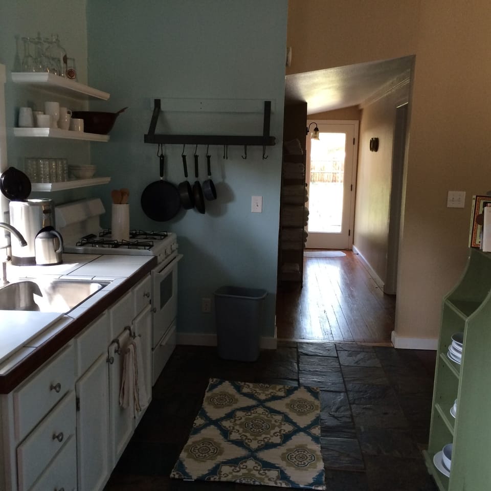 Kitchen, cooking area with gas stove and Circulon cookware.
