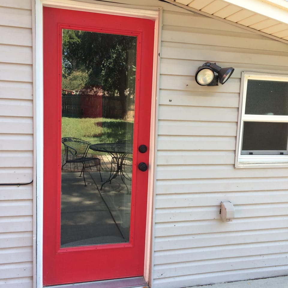 Patio door with reflection of backyard in window