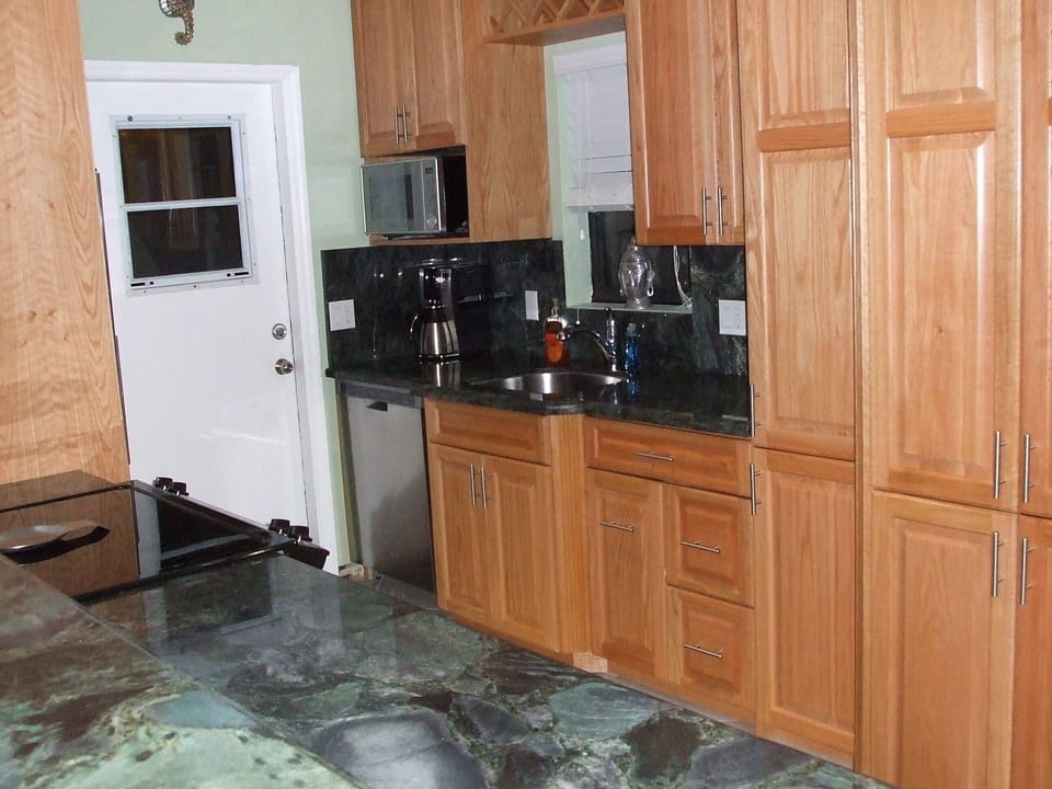 Gourmet kitchen & keyless back door to the laundry, storage, shower & beach.