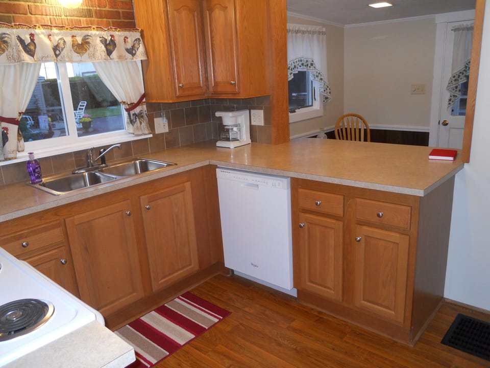 Kitchen has dishwasher, stove, oven, microwave, and refrigerator