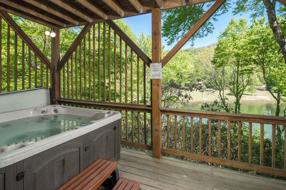 Relax in the private covered hot tub with peaceful lake and mountain views