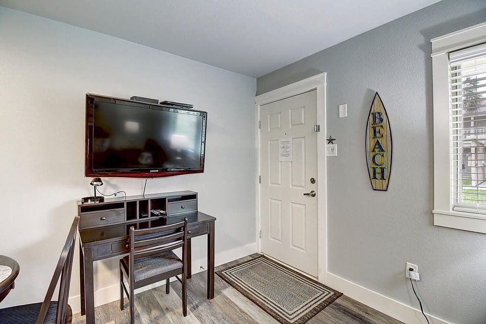 Relax in your coastal retreat with beach decor and modern entertainment center perfect for unwinding after seaside adventures.