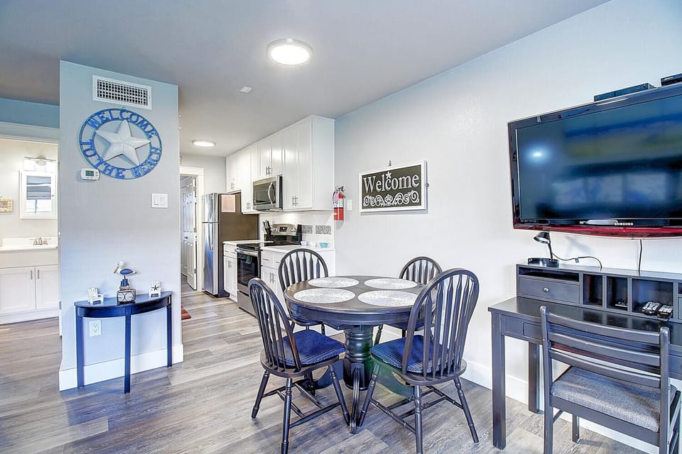 Your coastal-themed haven features a bright dining area with nautical touches, perfect for family meals and movie nights.