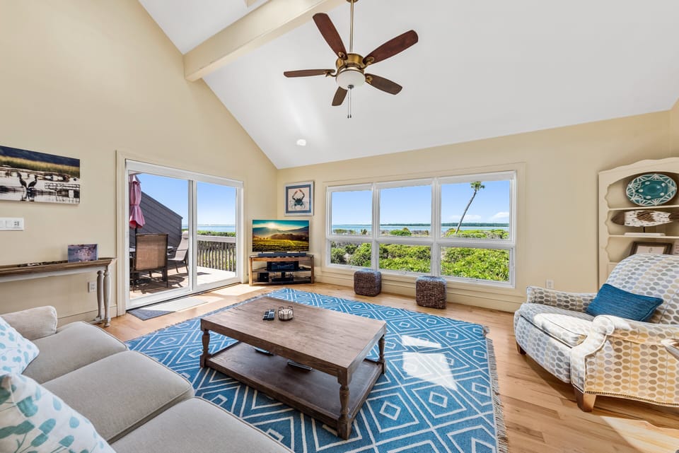 Sliding doors lead out to the side deck.  Vaulted ceilings add to the spacious feeling of this room