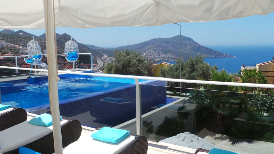 Sunbathing, swimming or just catching the breeze in  the basket chairs poolside